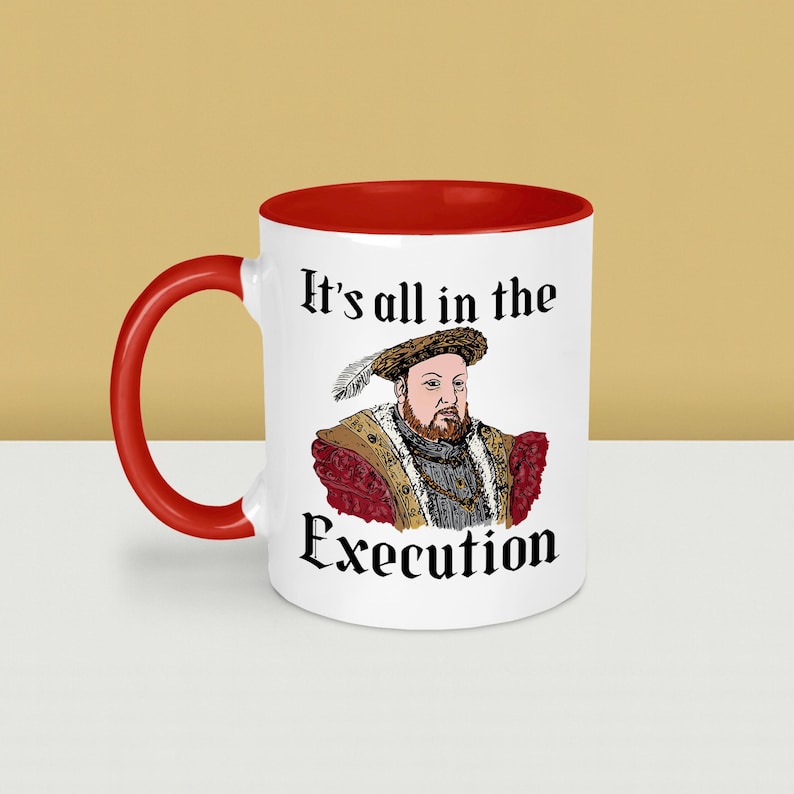 May include: White ceramic mug with a red interior and handle. The mug features a portrait of a historical figure and the text "It's all in the Execution" in black gothic font. The mug is a novelty item.