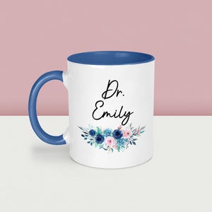 May include: A set of three ceramic mugs with a speckled, matte finish. The mugs are in shades of cream, light gray, and dark gray. Each mug has a simple, minimalist design, perfect for coffee or tea.