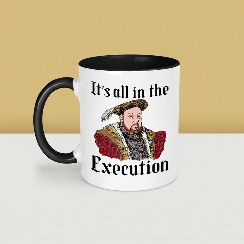 May include: White ceramic mug with a black interior and handle. The mug features a portrait of a historical figure with the text "It's all in the Execution". The design includes a detailed illustration of the figure in period clothing.