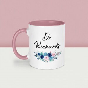 May include: A set of three ceramic mugs with a speckled, matte finish. The mugs are in shades of blue, green, and white. Each mug has a rounded handle and a simple, modern design. The mugs are likely for coffee or tea.