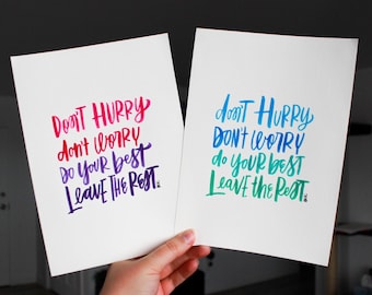 May include: Two white cards with the same inspirational quote written in different colors. The quote is "Don't hurry, don't worry, do your best, leave the rest."
