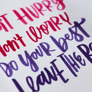 May include: Hand-lettered inspirational quote in pink and purple ink on white paper. The quote reads "Don't hurry, don't worry, do your best, leave the rest."