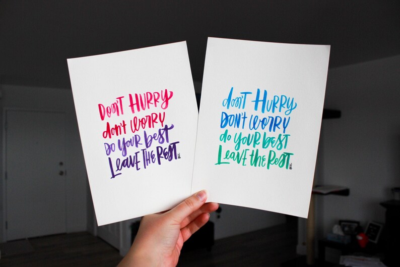 May include: Two white cards with the same inspirational quote written in different colors. The quote is "Don't hurry, don't worry, do your best, leave the rest."