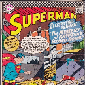May include: A comic book cover featuring Superman in a red and blue suit, standing on a rocky landscape. The cover text reads "Superman" and "The Mystery of Krypton's Second Doom!"