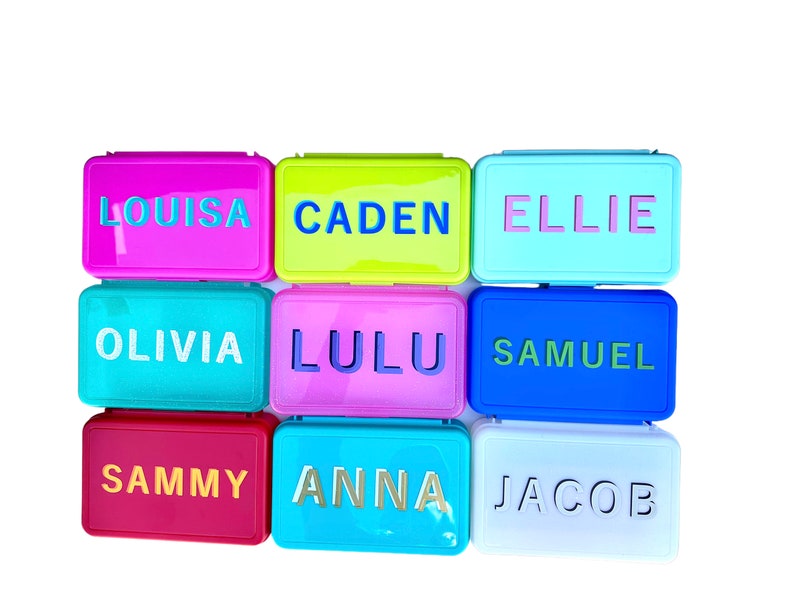 May include: Nine colorful rectangular boxes with different names written on them. The names are: Louisa, Caden, Ellie, Olivia, Lulu, Samuel, Sammy, Anna, and Jacob.