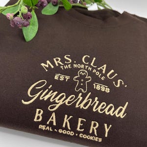 Mrs Clause Gingerbread Christmas Embroidered North Pole Sweatshirt,Santa claus gingerbread bakery Christmas Sweatshirt, Funny Christmas