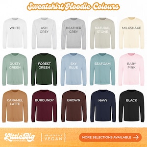 Sweatshirt and hoodie colour chart showing 15 options displayed on long-sleeve tops: White, Ash Grey, Heather Grey, Natural Stone, Milkshake, Dusty Green, Forest Green, Sky Blue, Seafoam, Baby Pink, Caramel Latte, Burgundy, Brown, Navy, and Black.