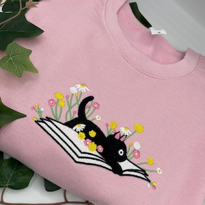 Embroidered Cute Cat Lying On Book With Flower Sweatshirt |  Bookish Cat lover Embroidered Hoodie | Cute autumn, Halloween cat book hoodie