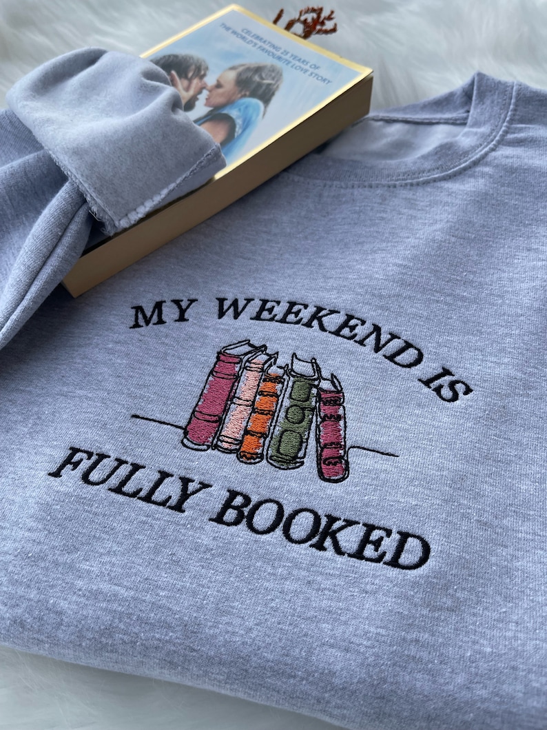 Grey sweatshirt with “My Weekend is Fully Booked” embroidered design