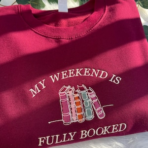 Red sweatshirt “My Weekend is Fully Booked” embroidered for book lovers