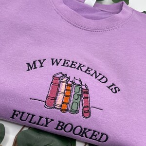 Purple sweatshirt “My Weekend is Fully Booked” embroidery book lover gift