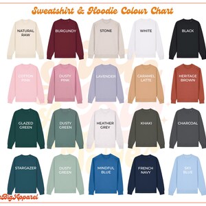 May include: Color chart for sweatshirts and hoodies showing 18 different color options. The colors include natural raw, burgundy, stone, white, black, cotton pink, dusty pink, lavender, caramel latte, heritage brown, glazed green, dusty green, heather grey, khaki, charcoal, stargazer, dusty green, mindful blue, french navy, and sky blue.