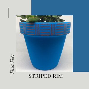 May include: A blue terracotta pot with a copper striped rim. The pot is empty and ready to be planted with a succulent or other small plant.