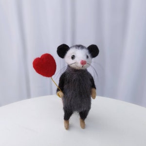 A needle felted opossum. Cute miniature wool possum