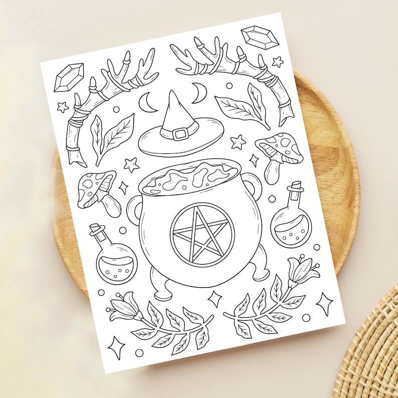 May include: A black and white line drawing of a witch's cauldron with a pentagram inside, surrounded by various magical elements like a witch's hat, mushrooms, crystals, and herbs.