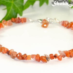 May include: A delicate ankle bracelet made with carnelian gemstone chips. The bracelet is strung on a silver chain and features a silver clasp.