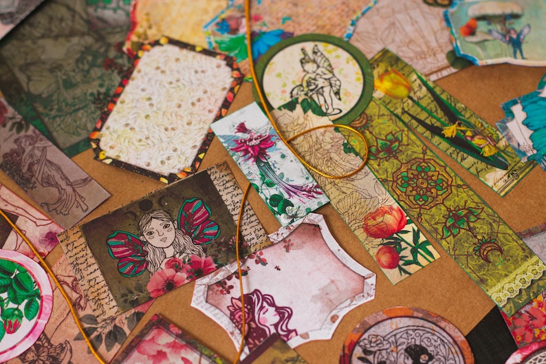 May include: Assortment of decorative paper ephemera with floral, fairy, and nature-inspired designs. The papers are in shades of green, brown, pink, and white.