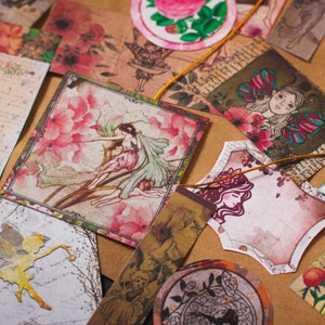 May include: Assortment of vintage-style paper ephemera with floral and fairy designs. The paper is printed with a variety of colors, including pink, green, blue, and brown. The paper is decorated with intricate details, such as flowers, butterflies, and fairies.