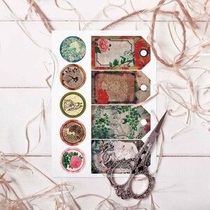 May include: A sheet of paper with six round stickers and four rectangular tags. The stickers and tags feature vintage-inspired designs with floral patterns, birds, and other decorative elements. The paper is on a white wooden surface with brown twine.