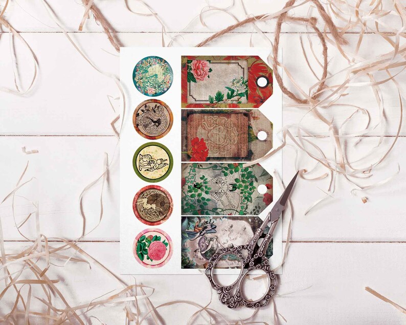 May include: A sheet of paper with six round stickers and four rectangular tags. The stickers and tags feature vintage-inspired designs with floral patterns, birds, and other decorative elements. The paper is on a white wooden surface with brown twine.