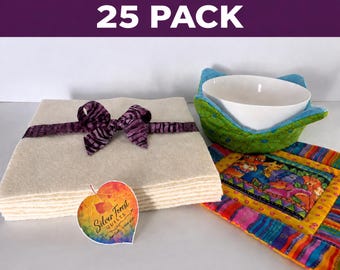 May include: A 25 pack of square cream-colored felt pieces tied with a purple patterned ribbon, a white ceramic bowl inside a green and blue quilted bowl cozy, and a colorful patterned quilted square mat with a Silver Forest Quilts leaf tag.