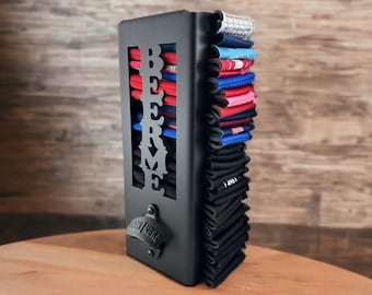 May include: Black metal beer can holder with the word "BEER ME" cut out. The holder has a built-in bottle opener and is filled with colorful koozies.