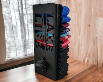May include: Black metal can holder with the words "Take Life" and a paddle design. The holder is filled with colorful koozies.