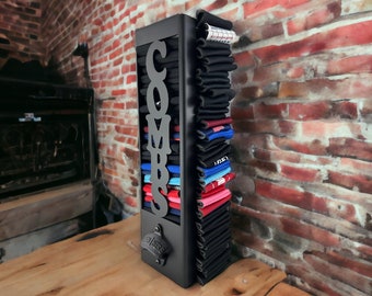 May include: A black metal wall-mounted organizer with the word "COMBS" in large letters. The organizer is filled with colorful socks.