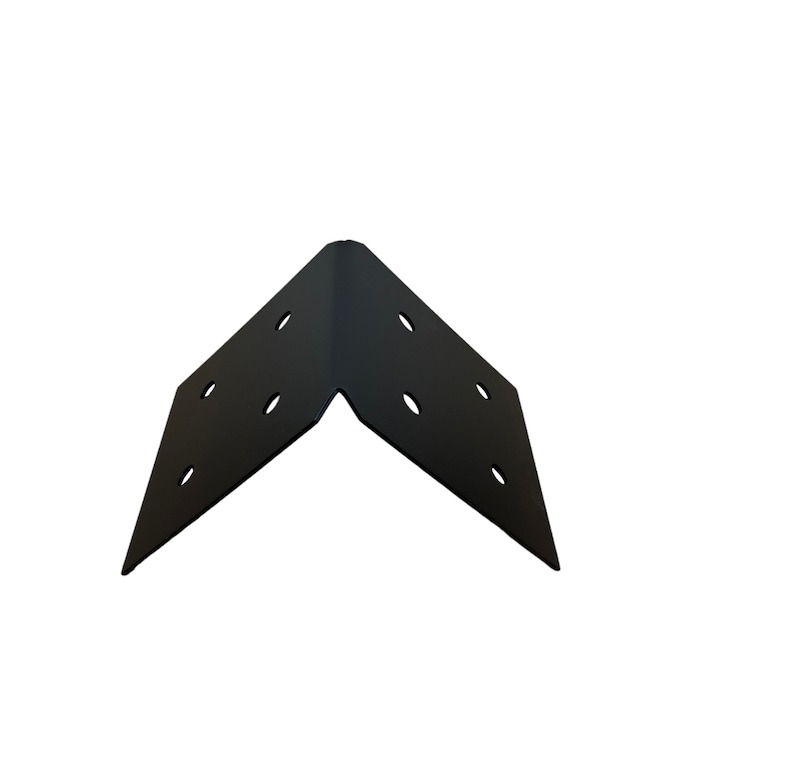 May include: A black corner brace with multiple pre-drilled holes for screws. The brace is made of metal and has a right-angle shape, designed for joining two pieces of material at a 90-degree angle. Ideal for woodworking and construction projects.