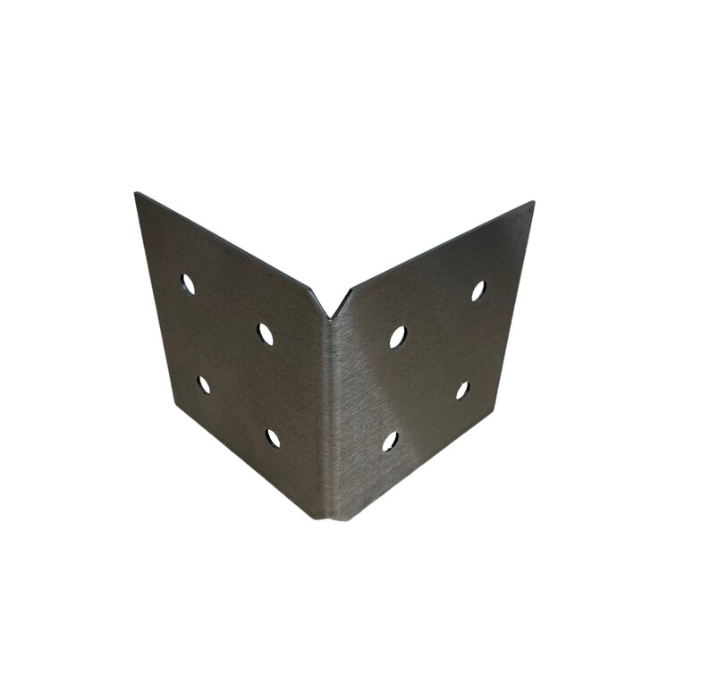 May include: A silver-colored, right-angle corner brace with six evenly spaced holes. The metal has a brushed texture, and the brace is designed to reinforce corners in woodworking or construction projects.