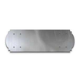 May include: A silver metal plate with rounded edges and multiple holes. The plate is designed for mounting.