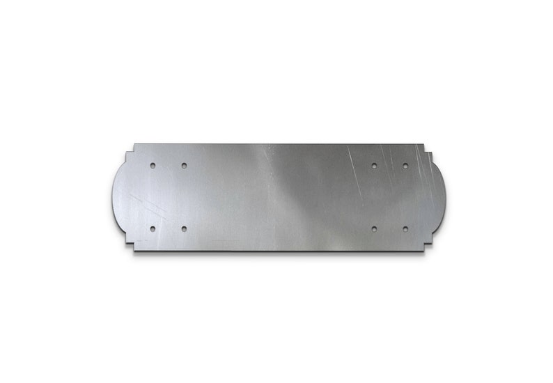 May include: A silver metal plate with rounded edges and multiple holes. The plate is designed for mounting.