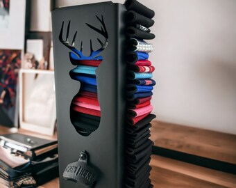May include: Black metal can holder with a deer silhouette cutout and a bottle opener that says "Open Here". The holder is filled with a stack of colorful can koozies.