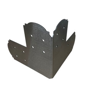 May include: A silver metal corner brace with multiple holes for attaching screws. The brace is designed to reinforce corners in construction projects.