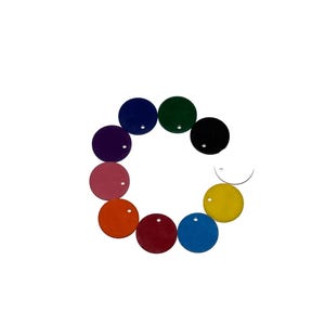 May include: A set of ten round, colorful, plastic discs with a small hole in the center. The discs are arranged in a circle, with the colors ranging from red to purple.