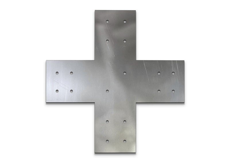 May include: A silver-colored metal cross-shaped bracket with multiple pre-drilled holes for mounting. The bracket is made of a flat, solid material and is designed for structural support. The surface has visible scratches.