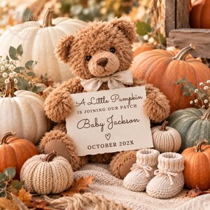 May include: A brown plush teddy bear with a cream-coloured bow tie holding a sign that reads A Little Pumpkin IS JOINING OUR PATCH Baby Jackson OCTOBER 202X, surrounded by various pumpkins and a pair of small cream-coloured knitted baby booties.