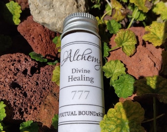 May include: A small, white bottle with a silver lid. The label reads "Alchemy Divine Healing 777 Spiritual Boundaries".