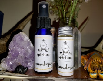 May include: Two small bottles with white labels and gold accents. The labels have a black and white illustration of an eye inside a crystal ball. The text on the labels reads "Spiritual Boundxries".