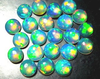 May include: A cluster of polished, spherical opals. Each opal exhibits a vibrant play of colour, including blue, green, yellow, and orange hues. The gemstones are closely arranged, highlighting their iridescent appearance and overall quality.
