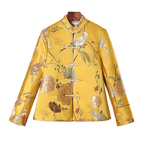 May include: A yellow jacket with a floral and bird pattern. The jacket has a mandarin collar and a button closure.