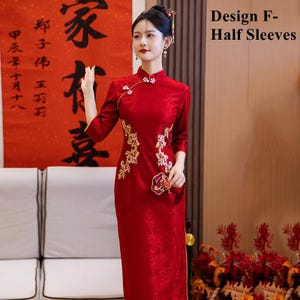 May include: A red cheongsam dress with gold embroidery and half sleeves. The dress has a mandarin collar and a fitted silhouette. The model is wearing the dress and standing in front of a red and gold background.