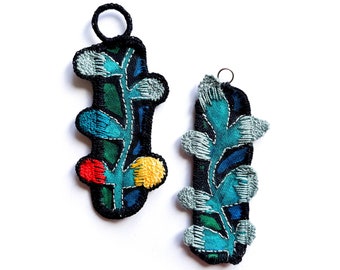 Small textile totems, wall charms, embroidered plant talismans