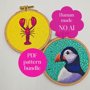 May include: Two circular wooden embroidery hoops featuring fabric art. One hoop has a yellow background with a red lobster and small beads. The other has a teal background with a puffin and scattered beads. Text reads Human made NO AI and PDF pattern bundle.