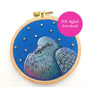 May include: An embroidered hoop art piece featuring a detailed depiction of a pigeon with iridescent feathers. The bird is set against a blue background with gold star accents. The text "PDF digital download" is in a pink circle.