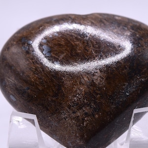May include: A heart-shaped polished stone with a brown and gray mottled pattern. The stone has a smooth, glossy finish.