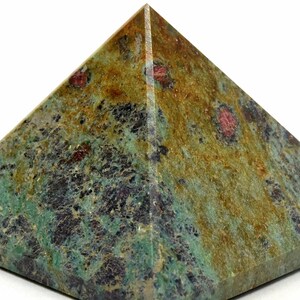 May include: A pyramid-shaped stone sculpture with a flat base. The pyramid features a mottled pattern of green, brown, and black hues, with small red inclusions. The stone has a polished appearance, and the pyramid shape is symmetrical.