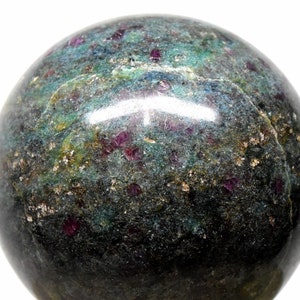 May include: A polished green and black sphere with red ruby inclusions. The sphere is made of a natural stone and has a smooth, glossy finish.