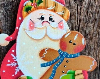 Santa holding a Gingerbread Ornament