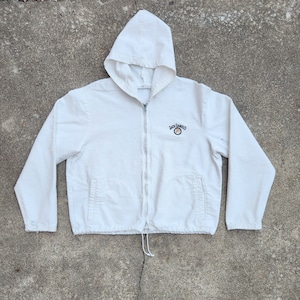 May include: White hooded jacket with a zipper closure and a Jack Daniel's logo embroidered on the front.